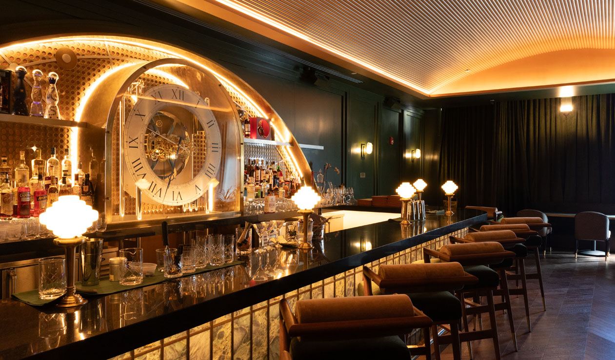 Backlit back bar with a large clock at Jupiter Supper Club
