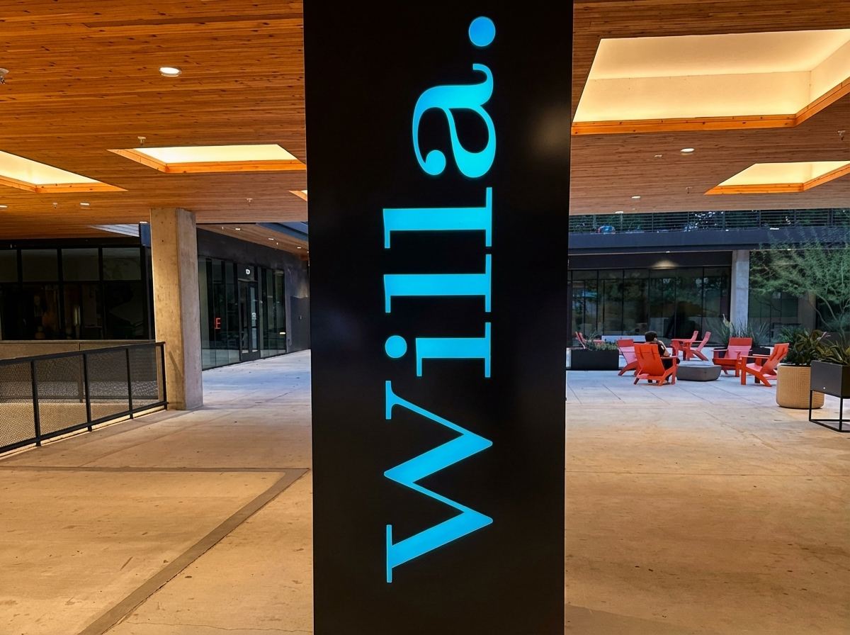 Black sign column with Willa lit in blue letters